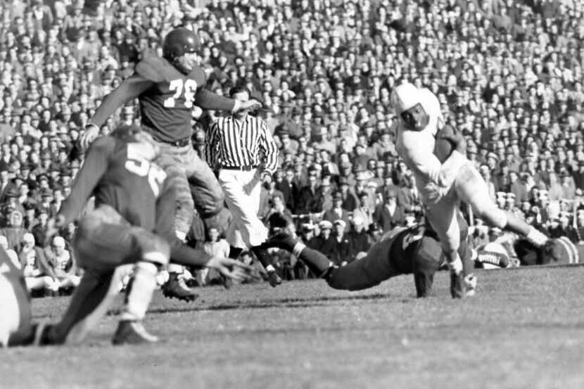 Penn State running back Wallace Triplett avoids an SMU tackler in the 1948 Classic. Triplett...