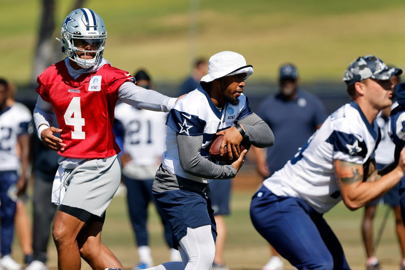 Dallas Cowboys quarterback Dak Prescott (4) hands the football off to running back Tony...