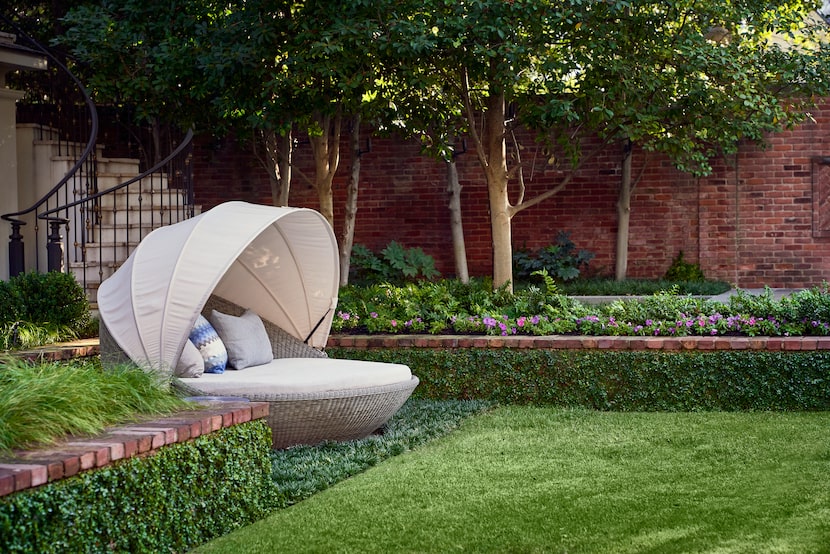 A canopy daybed provides a quiet, solitary place for lounging near the pool.