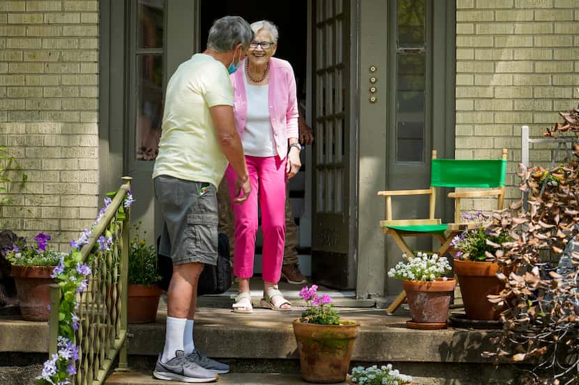 Vic Colon greets neighbor Jane Barker on her porch.