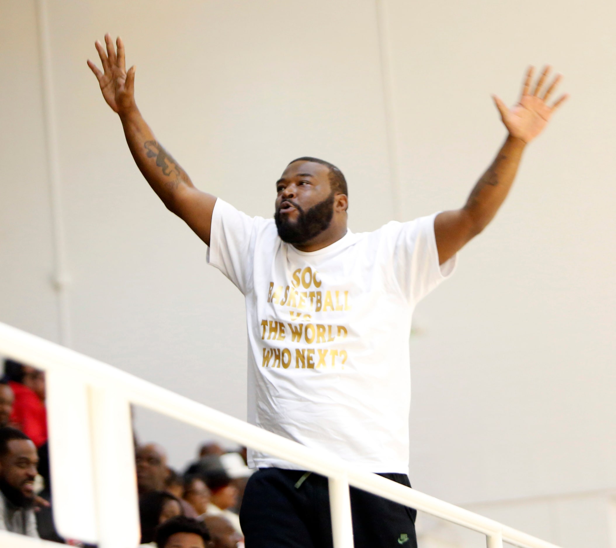 South oak Cliff fan Douglas Grace celebrates the shot that sent their game against Dallas...