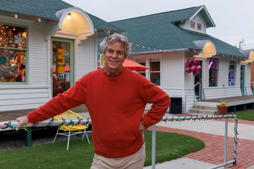 Good Space owner David Spence pictured outside of two remodeled houses turned small...