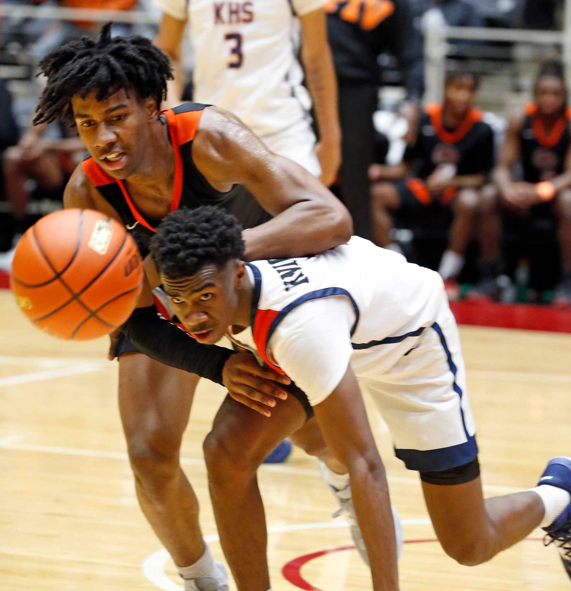 Lancaster High's Dillon Battie (4) and Kimball High’s T’Johnn Brown (2) vie for a loose ball...