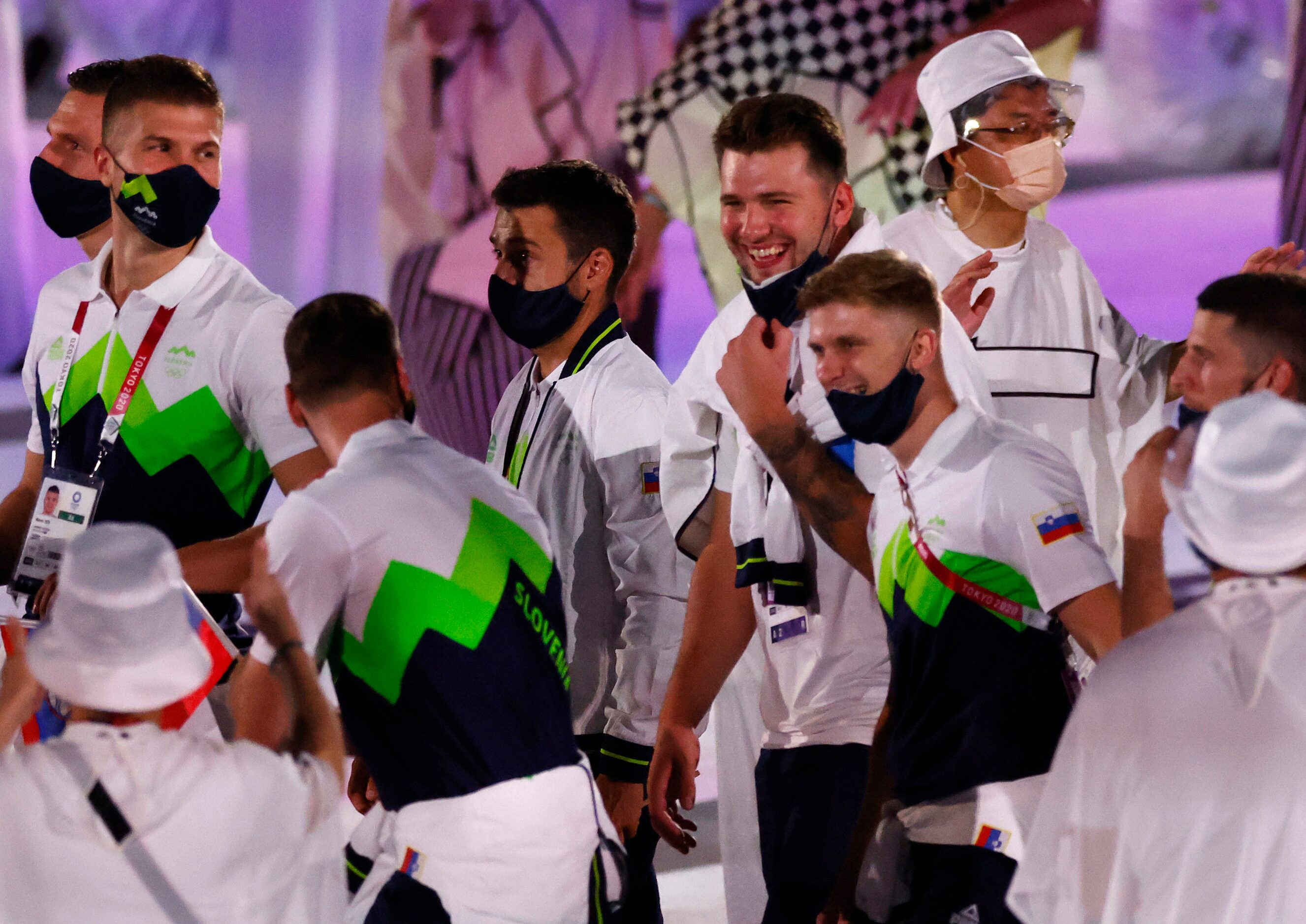 Slovenia’s Luka Doncic shares a laugh with is fellow Slovenian Olympic athletes as they make...