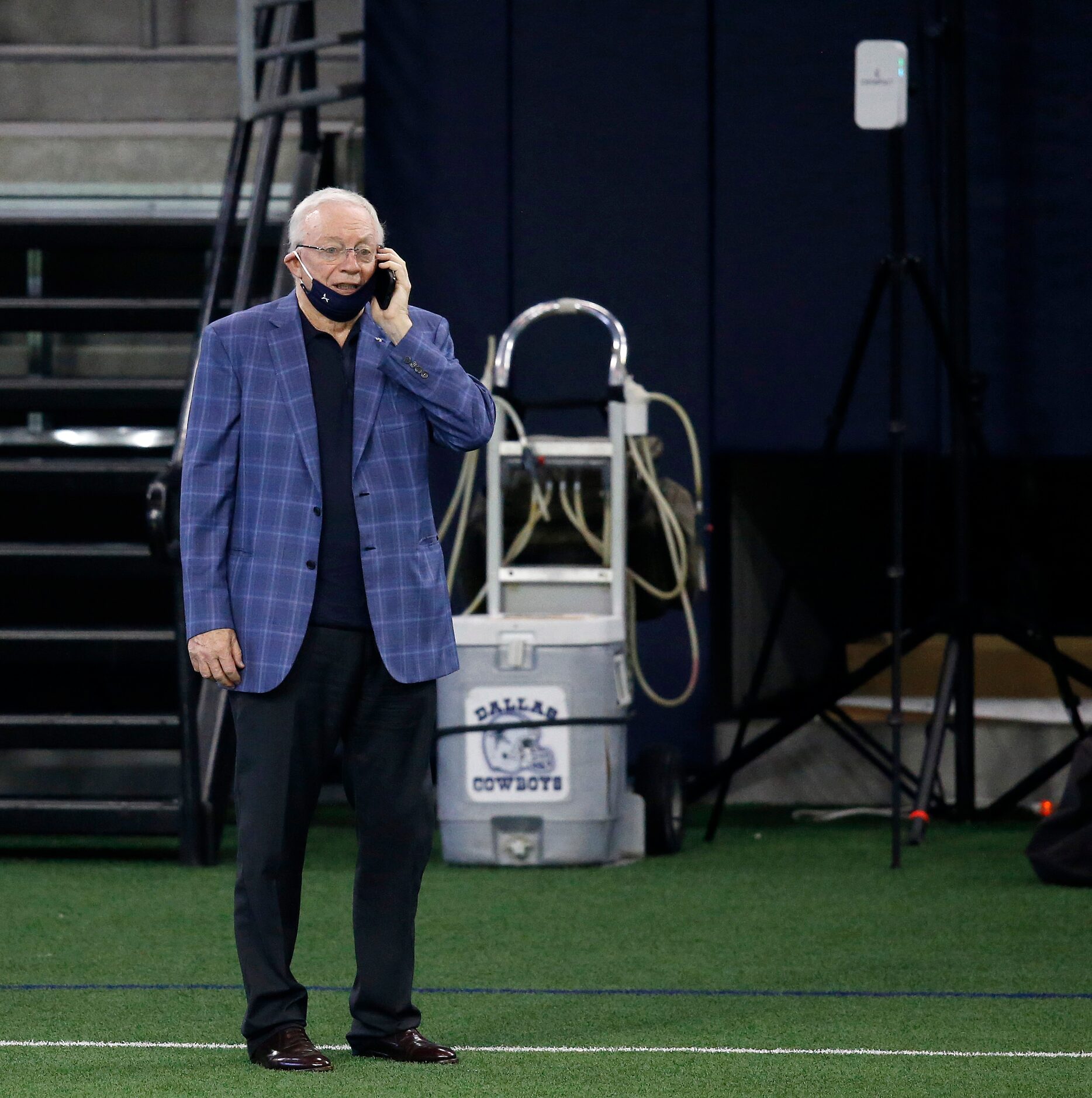 Dallas Cowboys owner and general manager Jerry Jones talks on the phone from the sidelines...