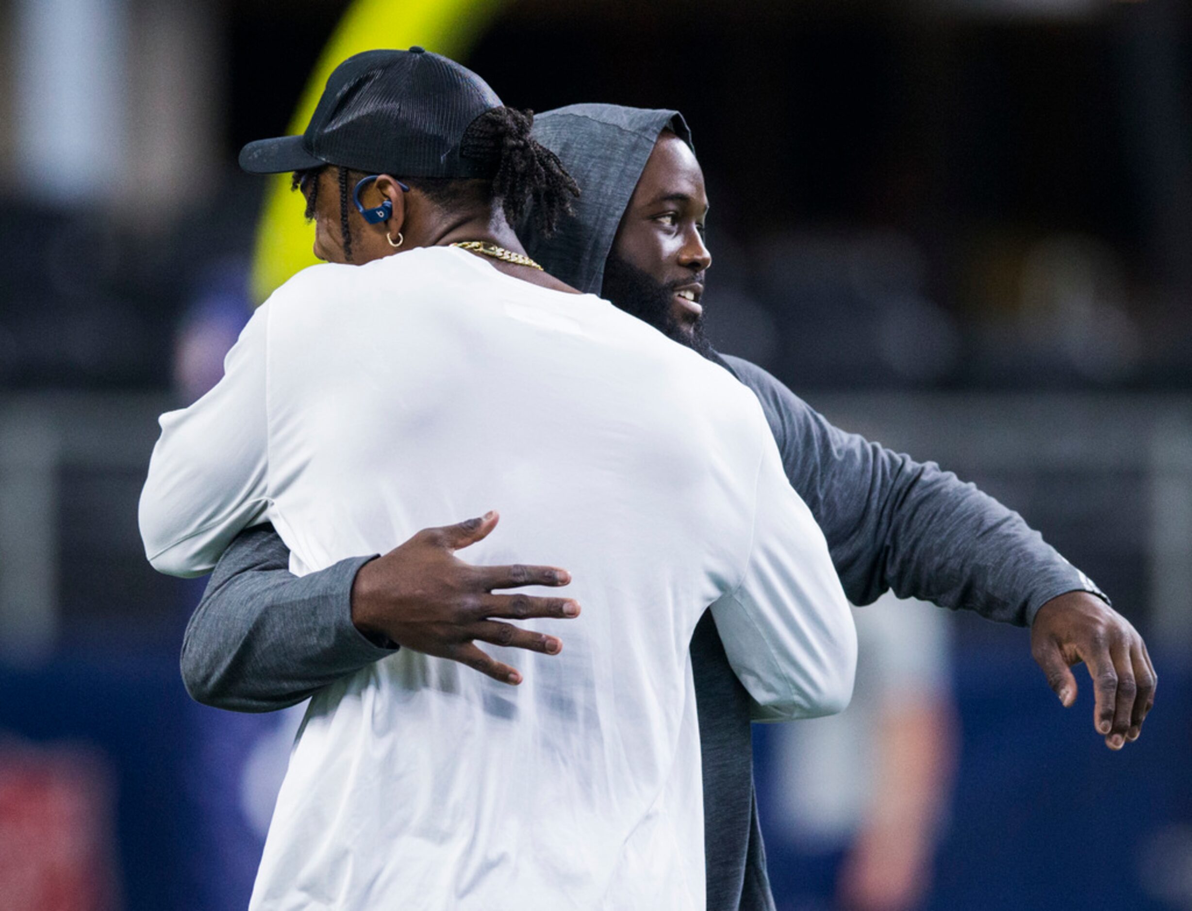 Miami Dolphins defensive end Taco Charlton (96) hugs Dallas Cowboys defensive tackle Maliek...