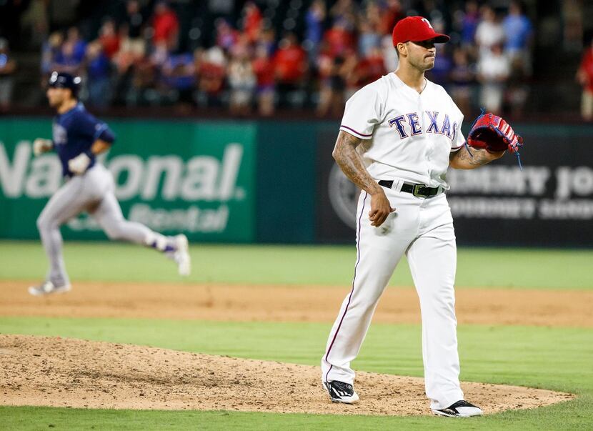 Texas Rangers relief pitcher Matt Bush waits for a new ball as Tampa Bay Rays center fielder...