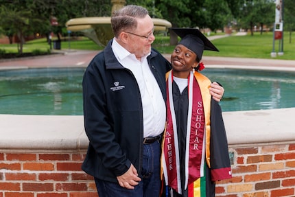 Hana Taylor Schlitz poses with her adoptive father, William Schlitz, on the campus of Texas...