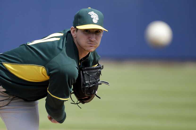 In this March 5, 2014, file photo, Oakland Athletics' Jarrod Parker throws before an...