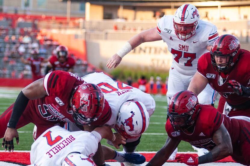 FILE - Arkansas State defensive end William Bradley-King (upper left) sacks SMU quarterback...