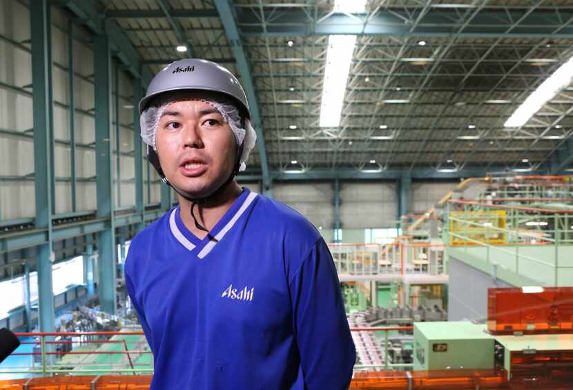 Asahi Breweries plant manager Shinichi Uno is shown near the production line at a factory in...