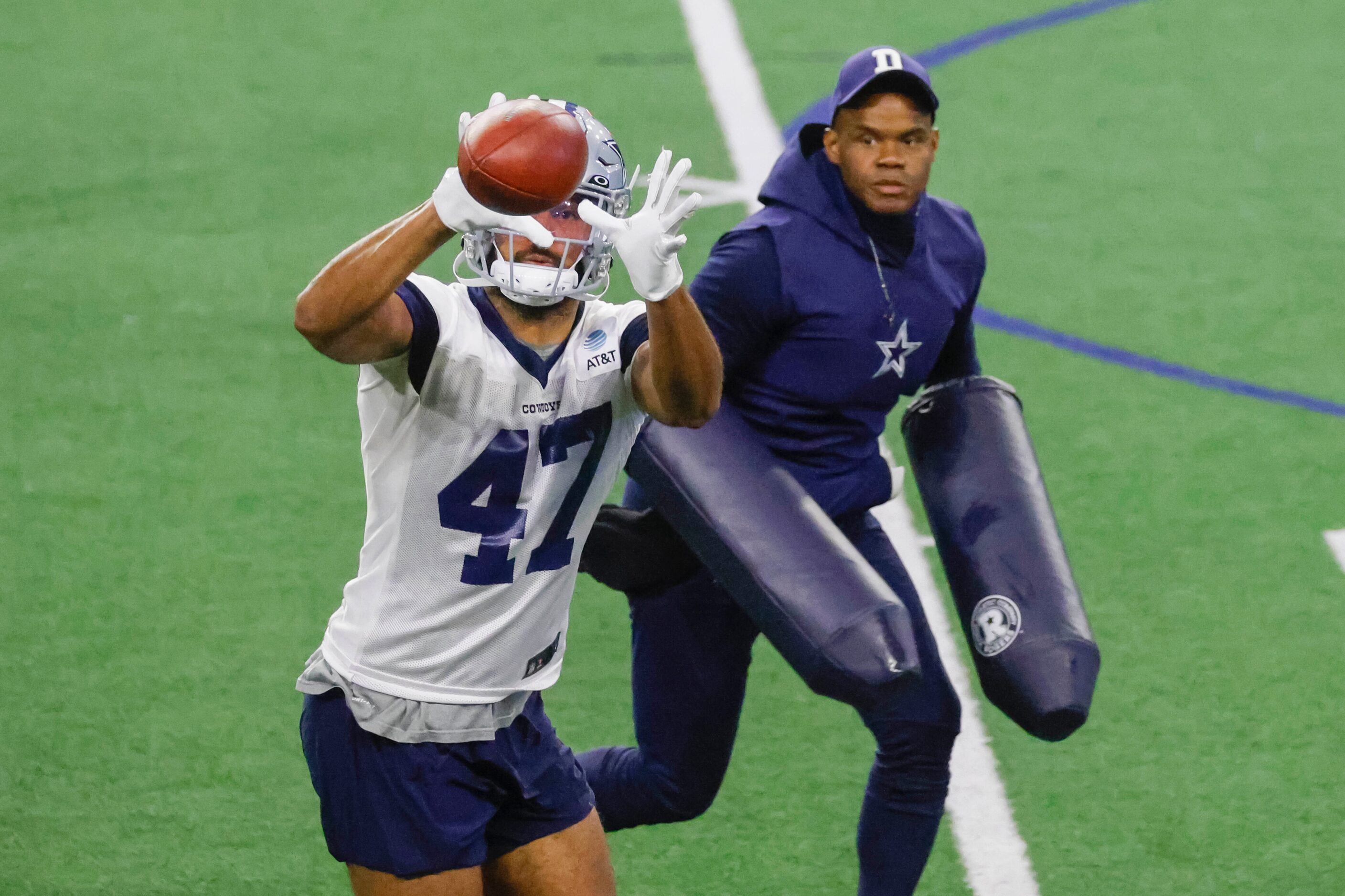 Dallas Cowboys tight end Seth Green (left) receives the ball past tight end coach Lunda...