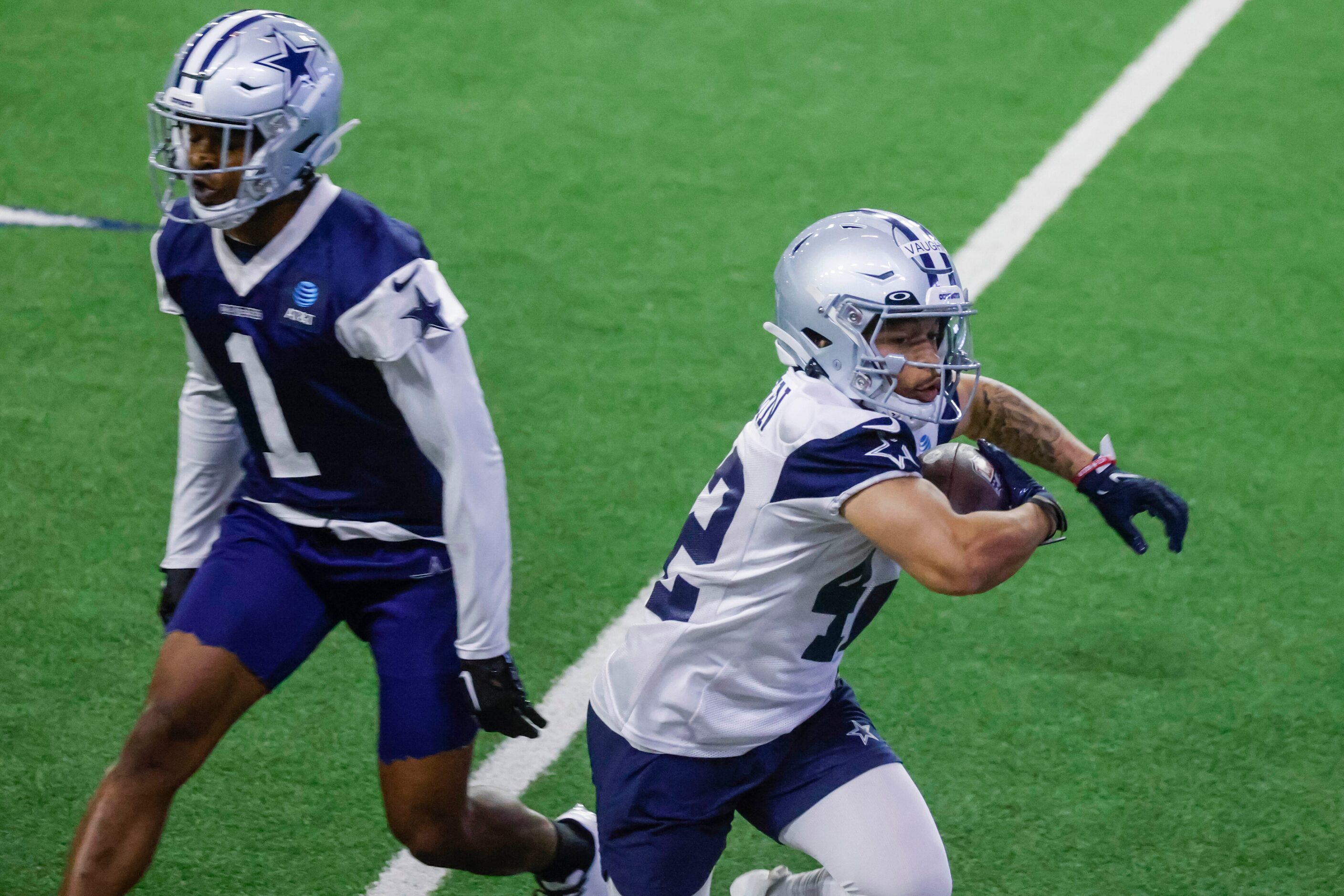 Dallas Cowboys running back Deuce Vaughn (right) goes past  cornerback Kelvin Joseph during...