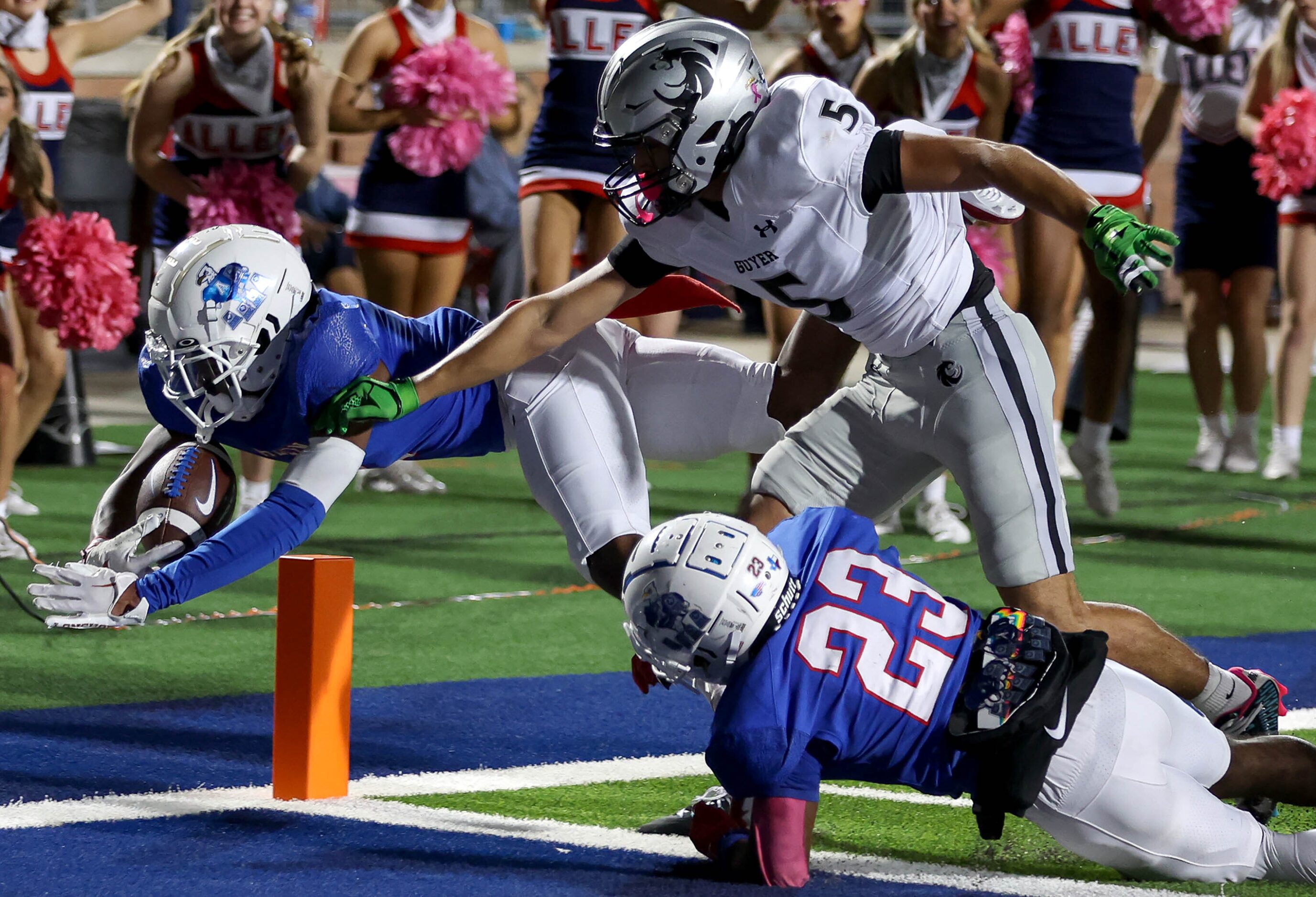 Allen wide receiver Caleb Smith (left) gets past Denton Guyer defensive back Alexis Alvarez...