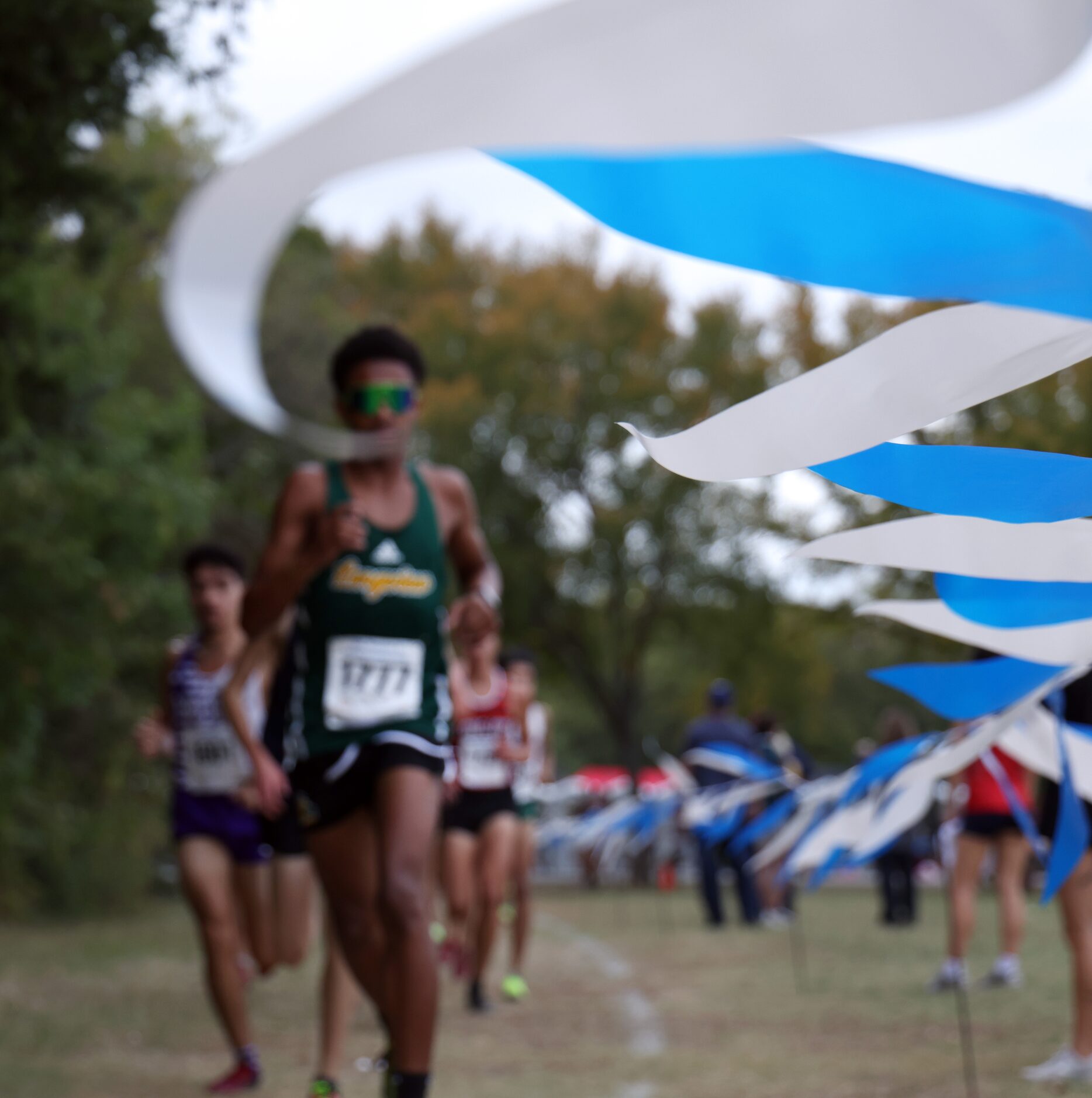 Runners pass the midpoint of the Boys Class 5A Region 2 race. The Class 5A Region 2 boys and...