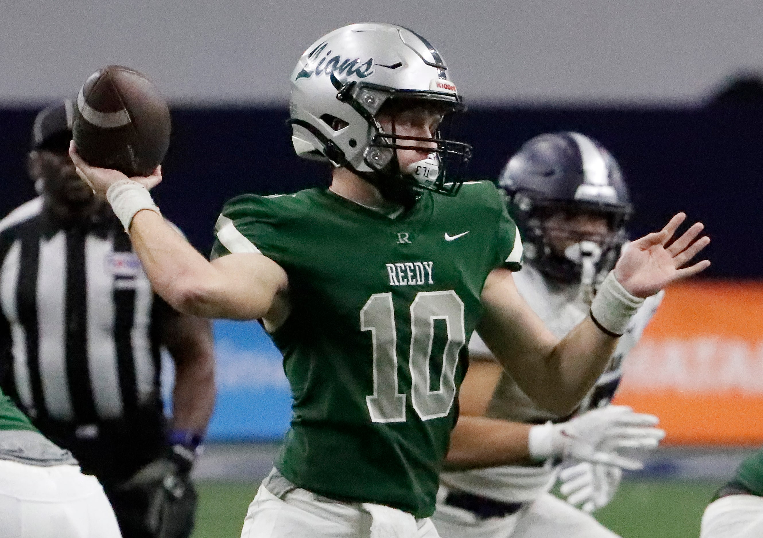 Reedy High School quarterback Jake Ferner (10) throws a touchdown pass during the first half...