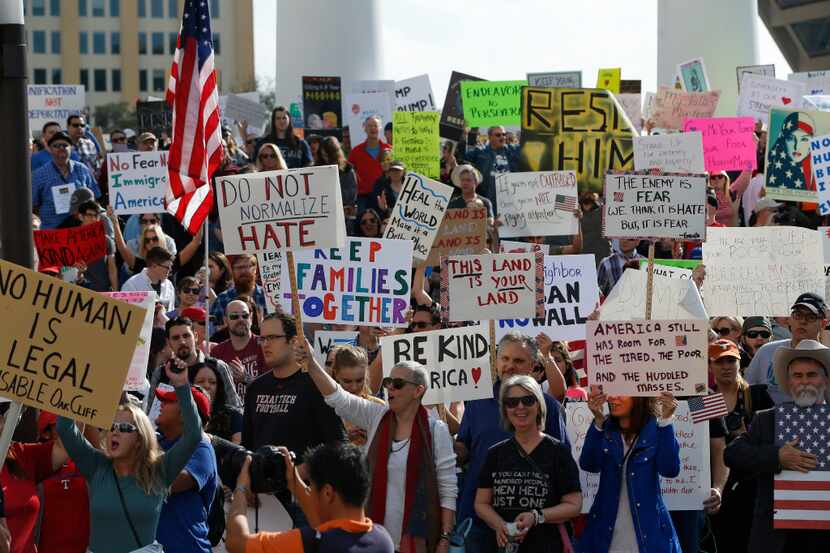 Protesters rally in support of immigrants and refugees in downtown Dallas Feb. 18 to show...