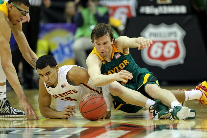 Naz Long #15 of the Iowa State Cyclones and Brady Heslip #5 of the Baylor Bears scramble for...