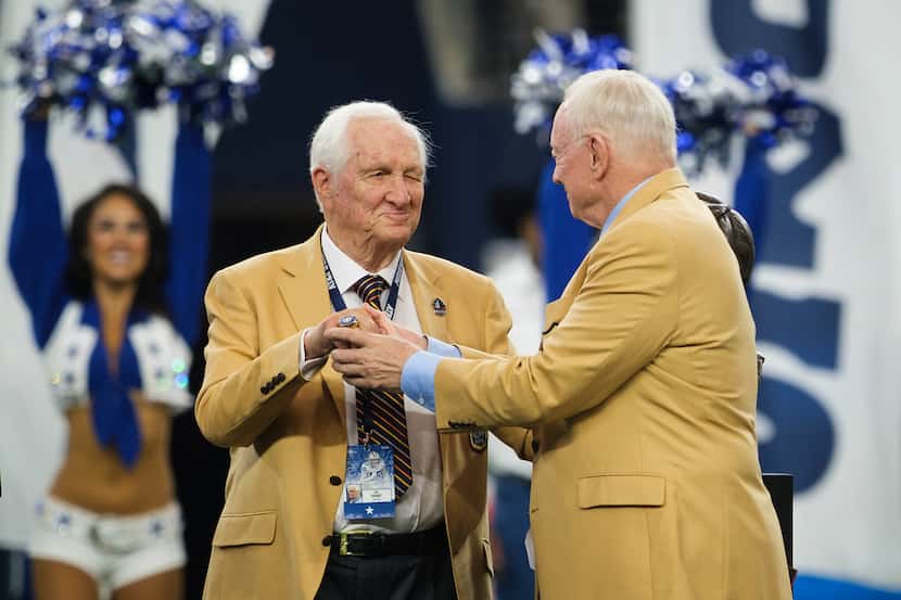 Gil Brandt is presented with his NFL Hall of Fame ring by Jerry Jones during halftime of an...