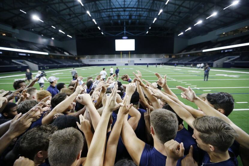 Lone Star High School team prepares to go through a light practice on the field at Frisco's...