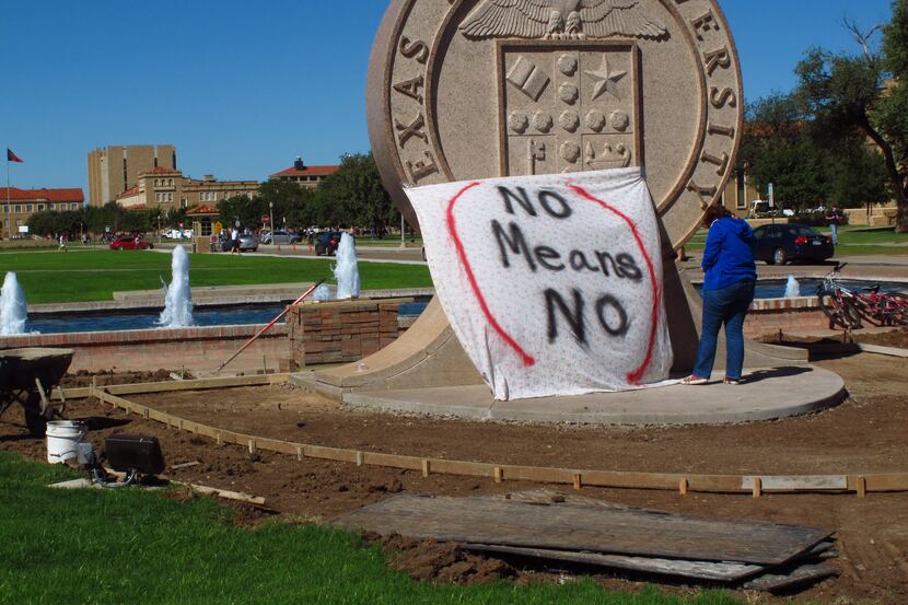 Texas Tech freshman Regan Elder helped drape a bed sheet with the message "No means No" over...