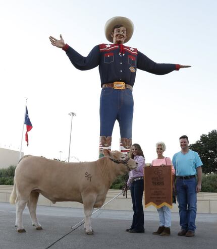 Laurel Kelley, 15, left, posed Thursday with her Grand Champion Steer, RFD, in front of Big...