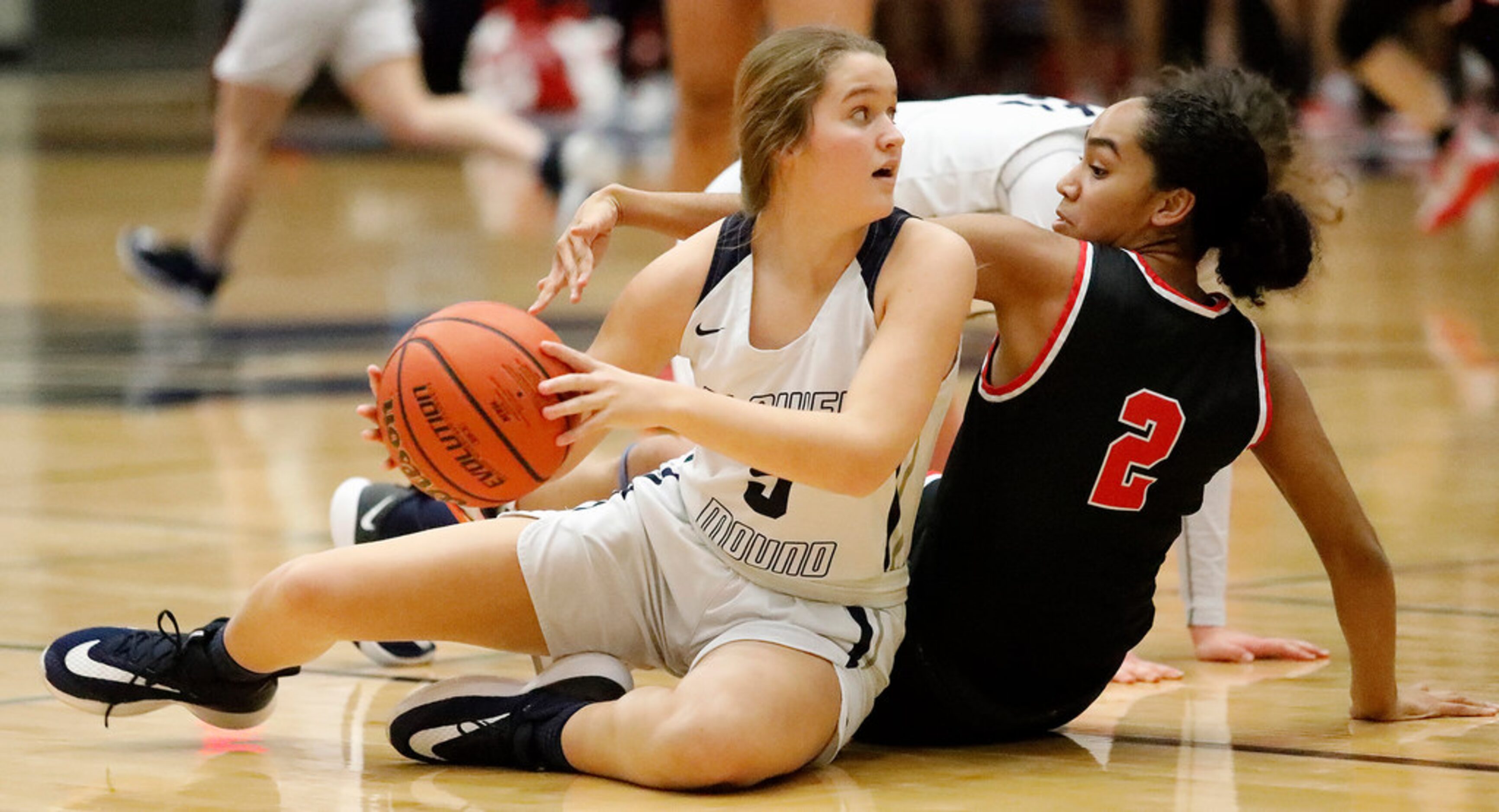 Flower Mound High School guard Hailey Bingham (5) picks up a loose ball on the floor as...