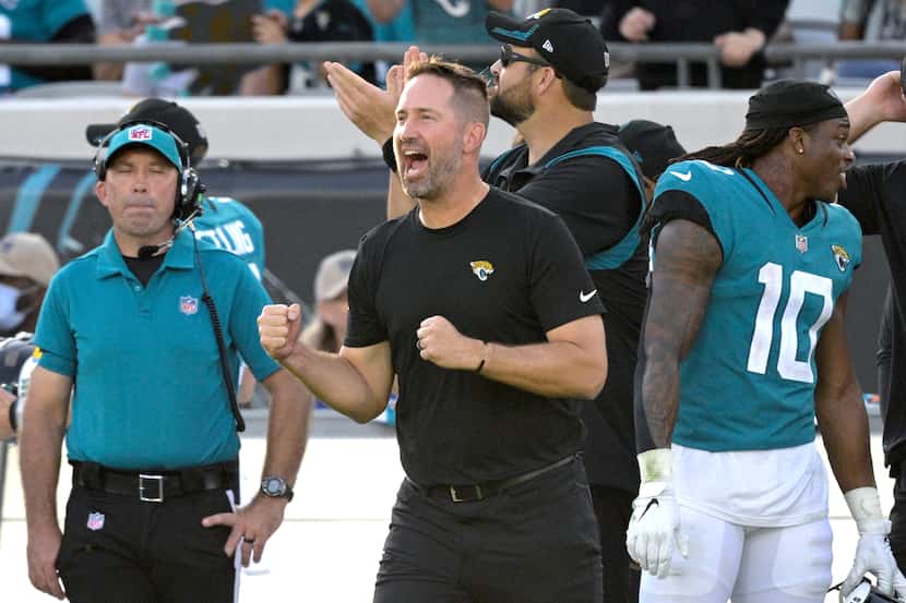 Jacksonville Jaguars passing game coordinator Brian Schottenheimer, front, reacts as time...