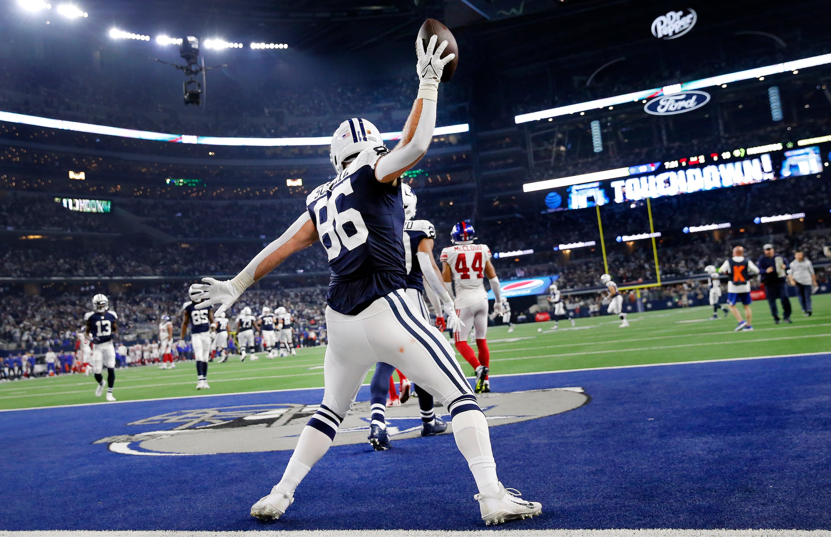 Dallas Cowboys tight end Dalton Schultz (86) spikes the ball in the end zone after his third...