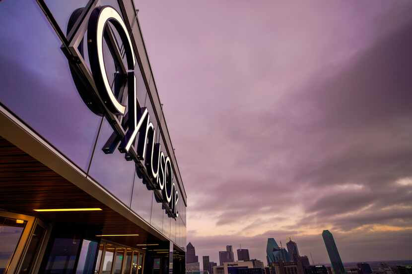 The CyrusOne logo hangs above the terrace overlooking downtown on Monday, Dec. 16, 2019, in...