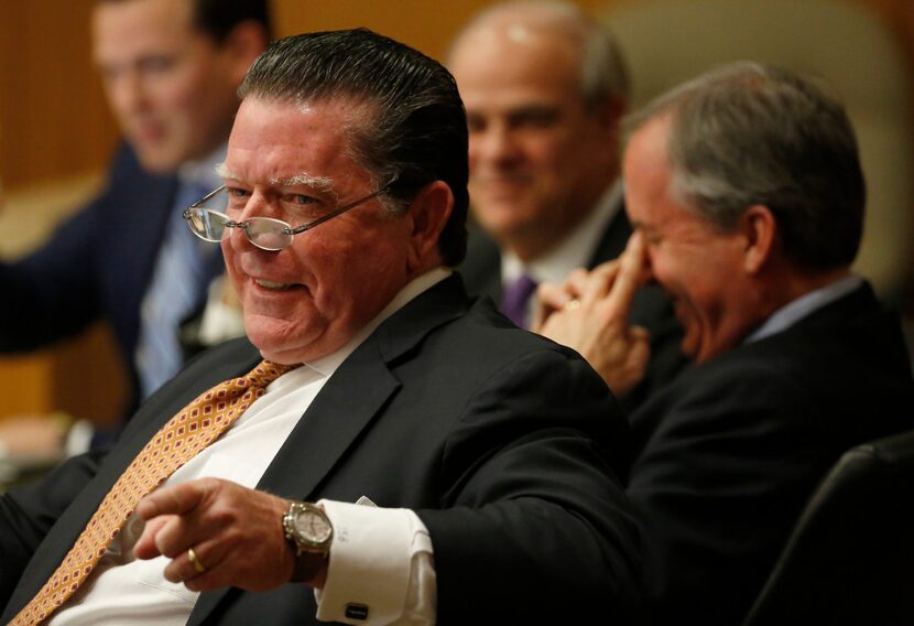 Dan Cogdell (left), an attorney for Attorney General Ken Paxton, jokes at the defense table...