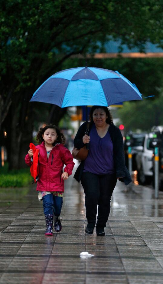 Connie Serna and her daughter Olivia ran to Sunday school at Cathedral Santuario de...