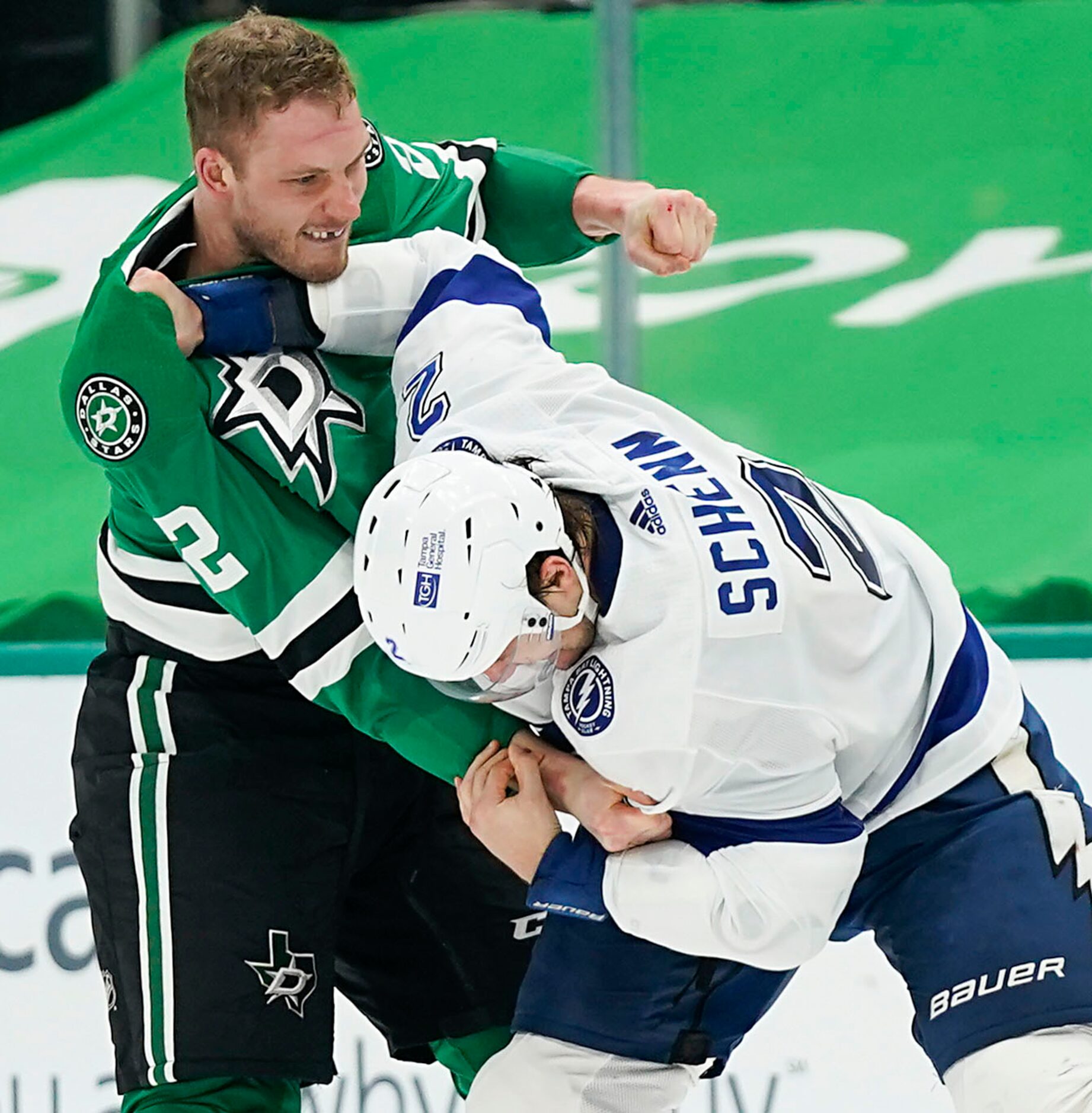 Dallas Stars defenseman Jamie Oleksiak (left) fights with Tampa Bay Lightning defenseman...