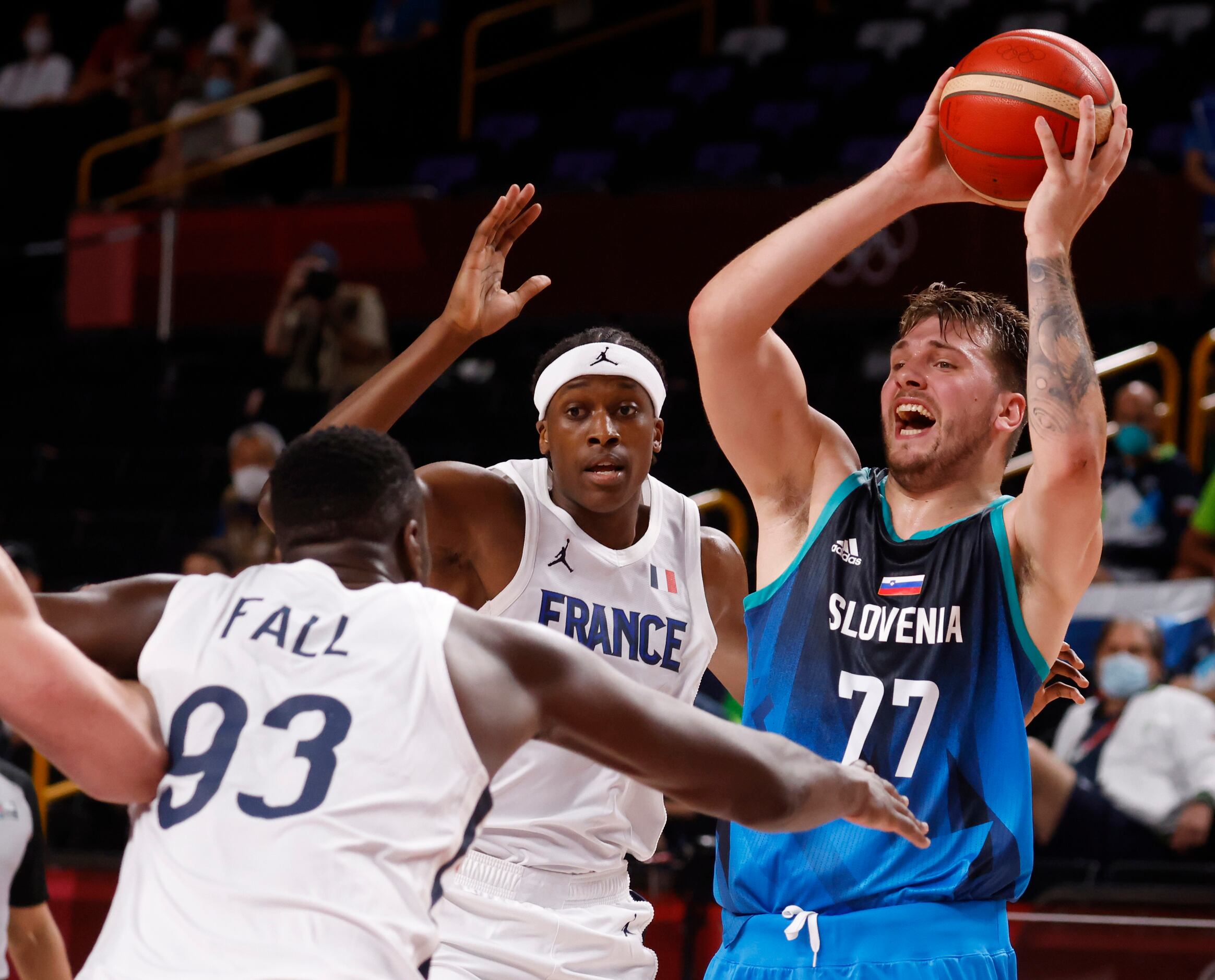 Slovenia’s Luka Doncic (77) looks to pass as France’s Moustapha Fall (93) steps up to defend...
