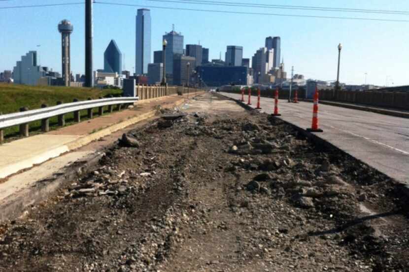 Workers are clearing a portion of the Houston Street Viaduct in preparation for the...