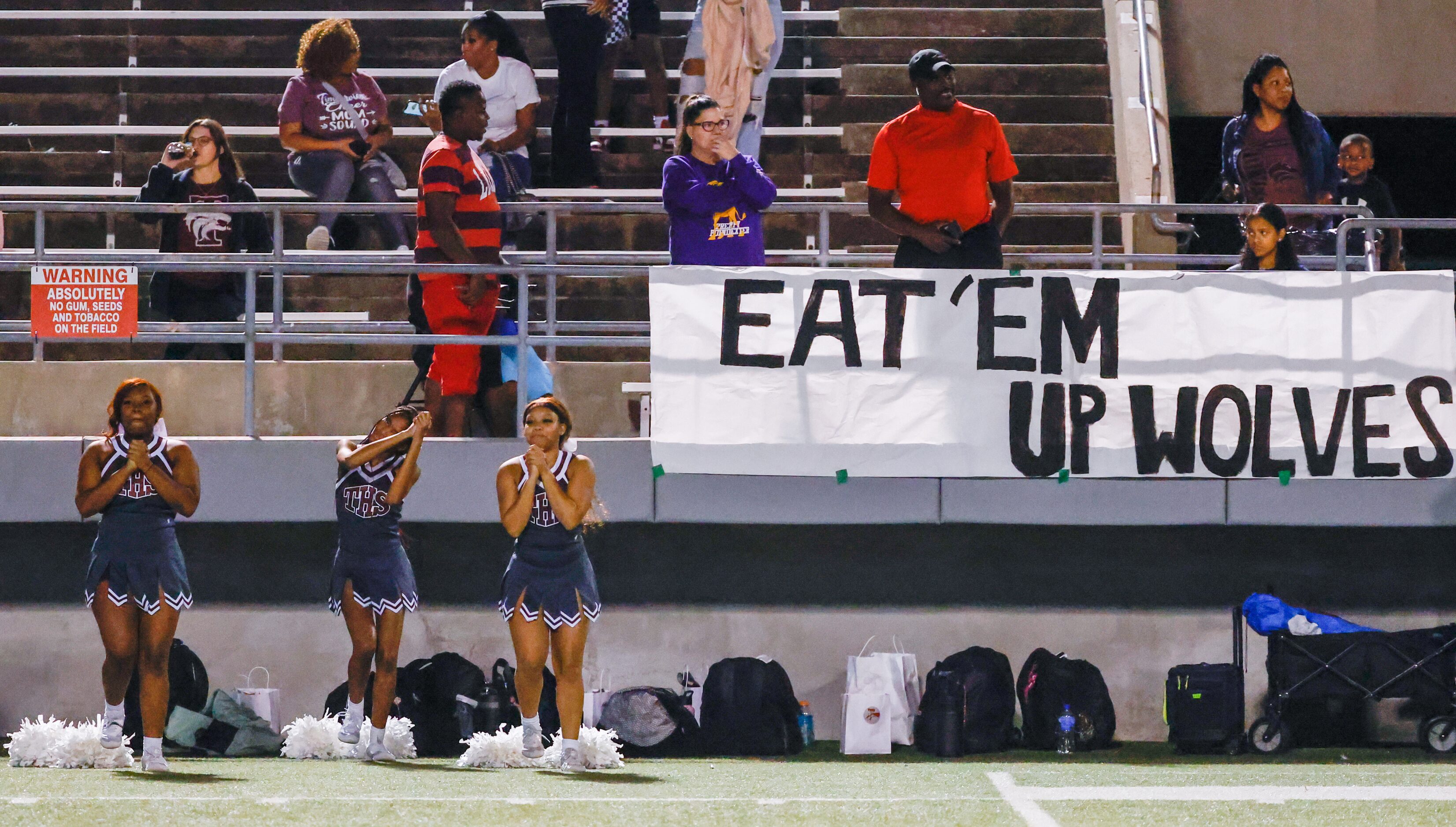 Mansfield Timberview cheerleaders lead a chant during the last quarter of a game against...