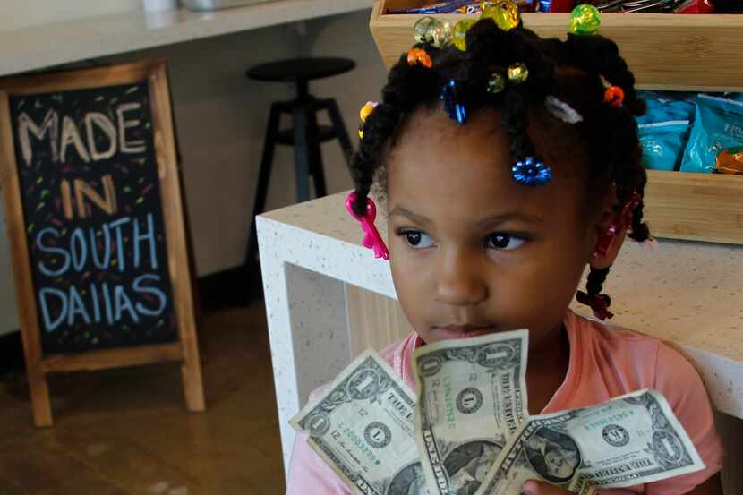 Miah Cooper, 5, ponders a variety of snacks available at the Southpoint Community Market....