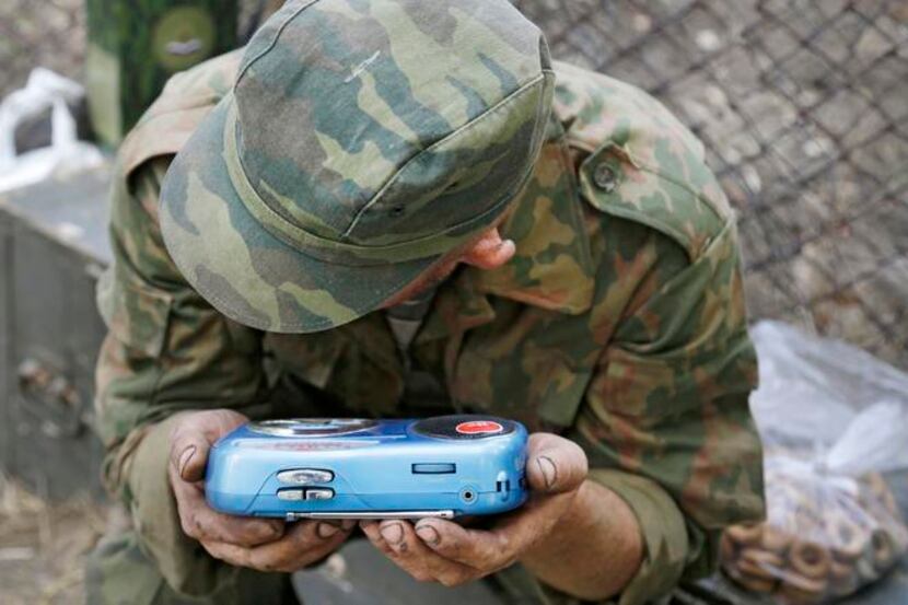 
A pro-Russia rebel listened intently Friday to a news report on a transistor radio in the...