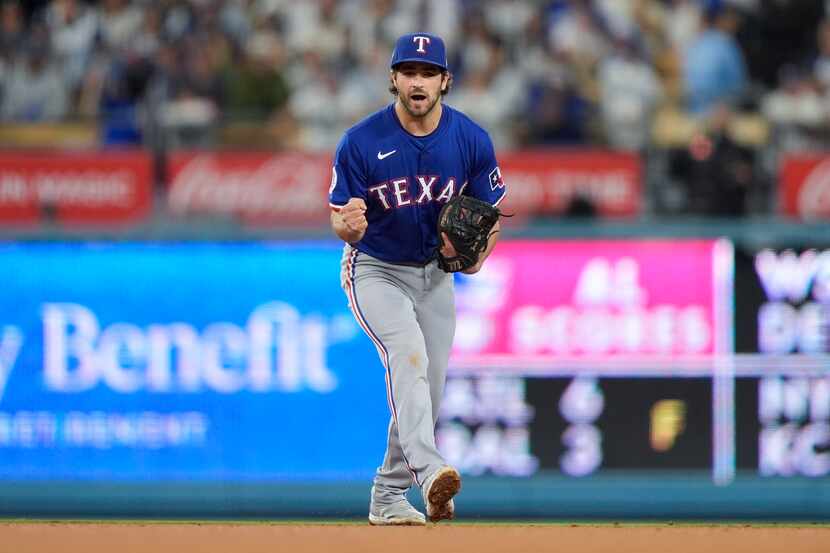Texas Rangers shortstop Josh Smith reacts after Los Angeles Dodgers' Freddie Freeman struck...