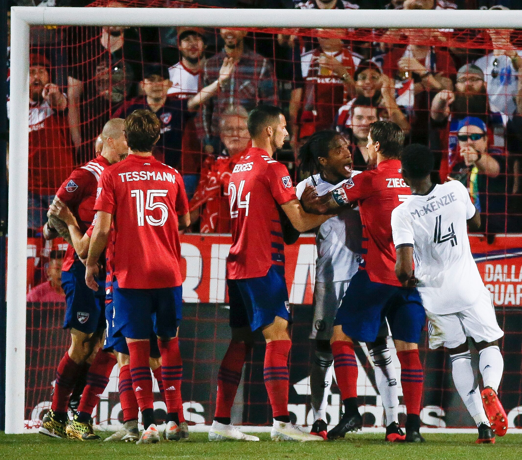 Philadelphia Union attacker Sergio Santos (17) clashes with FC Dallas players briefly during...