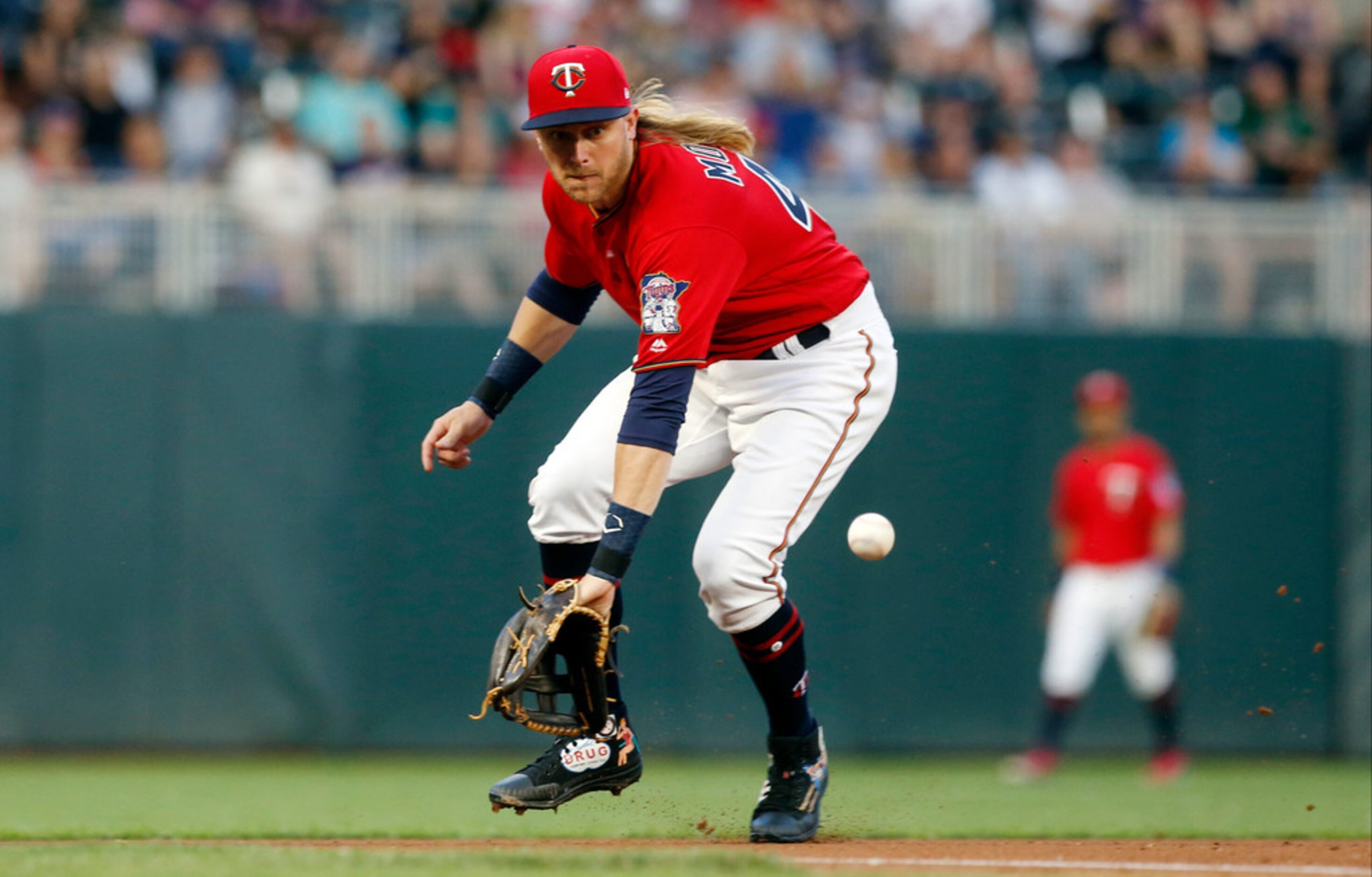 Minnesota Twins third baseman Taylor Motter fields a grounder on a single by Texas Rangers'...