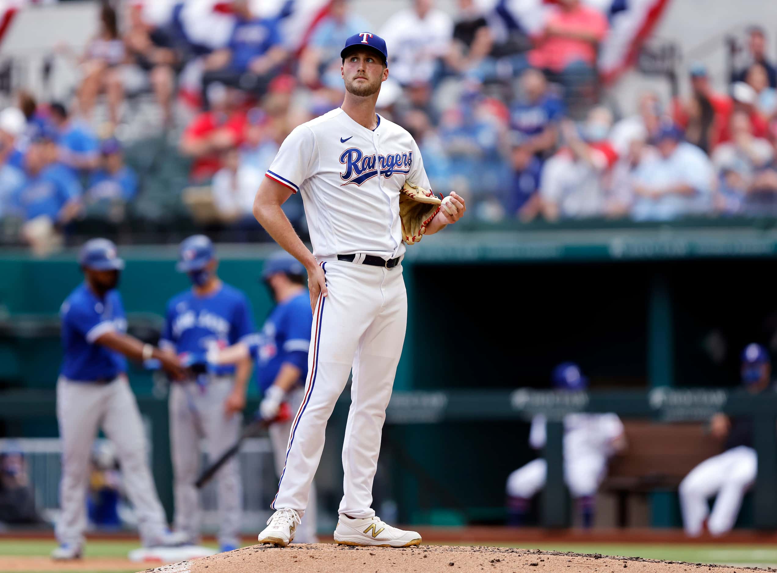 Texas Rangers starting pitcher Kyle Cody (54) looks to the video replay after Toronto Blue...