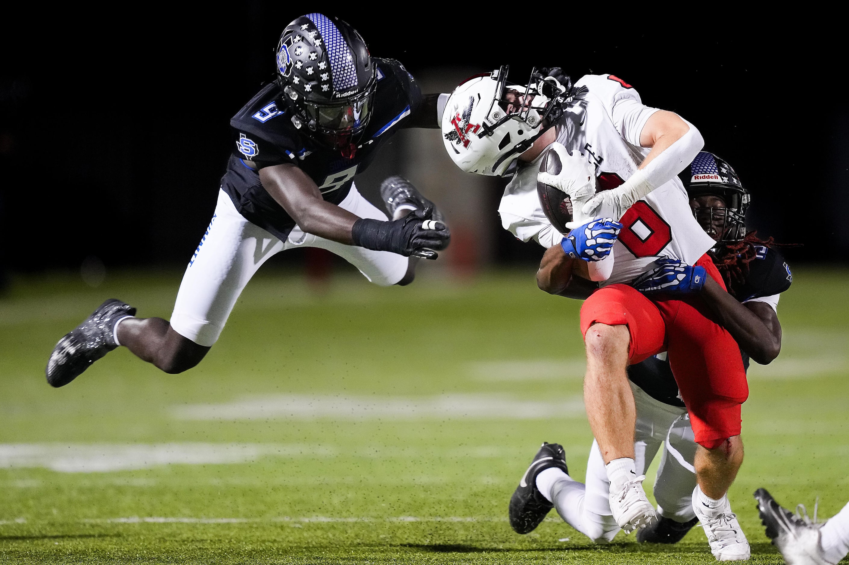 Argyle running back Watson Bell (6) is pulled backwards on a facemask penalty by Mansfield...