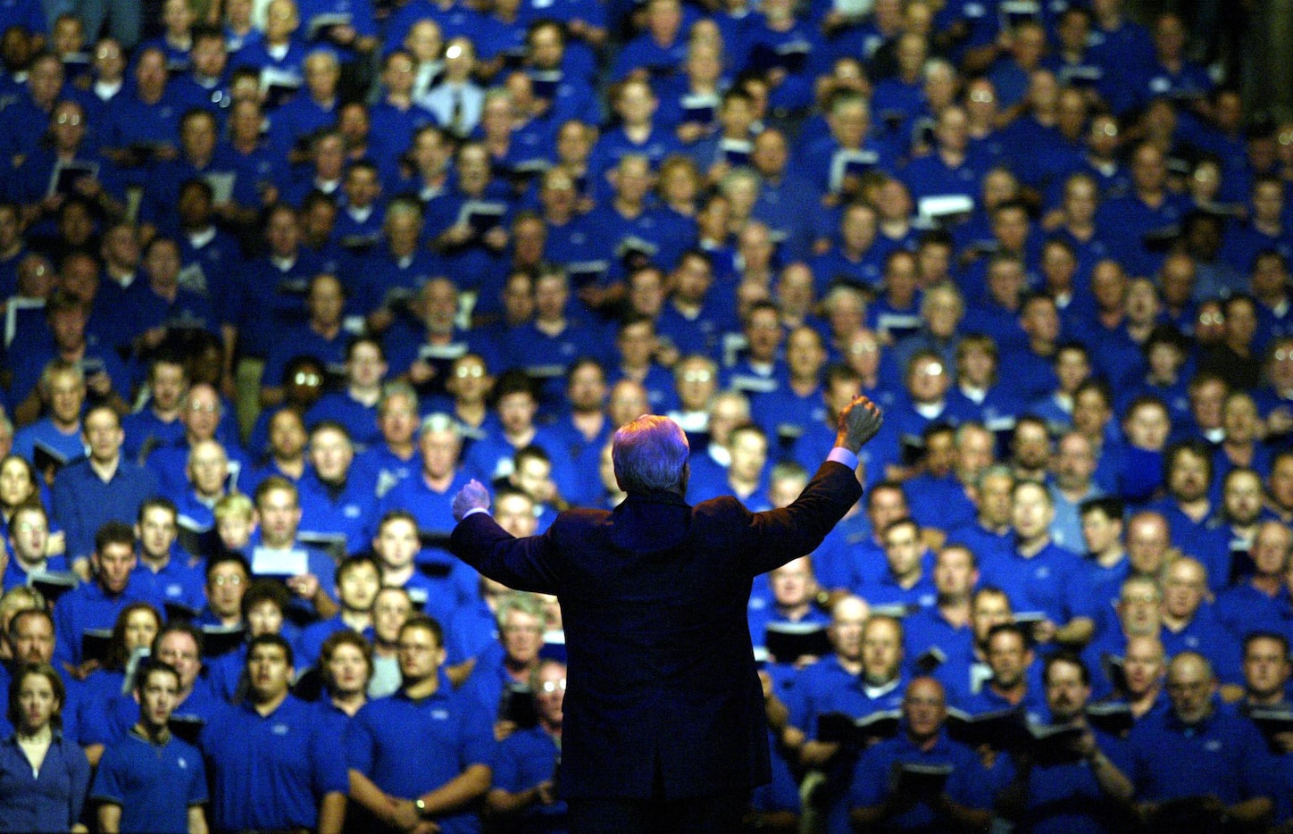 Oct. 17, 2002: Cliff Barrows leads the choir in song  on stage at the Billy Graham Crusade...