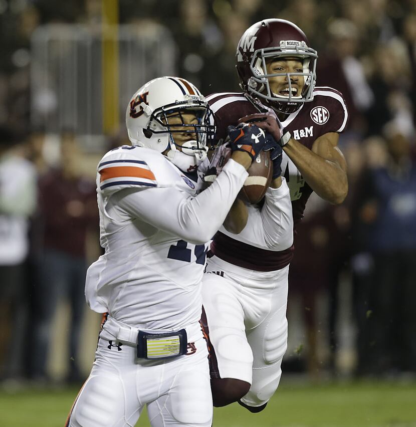Carlton Davis #18 of the Auburn Tigers intercepts a pass intended for Damion Ratley #4 of...