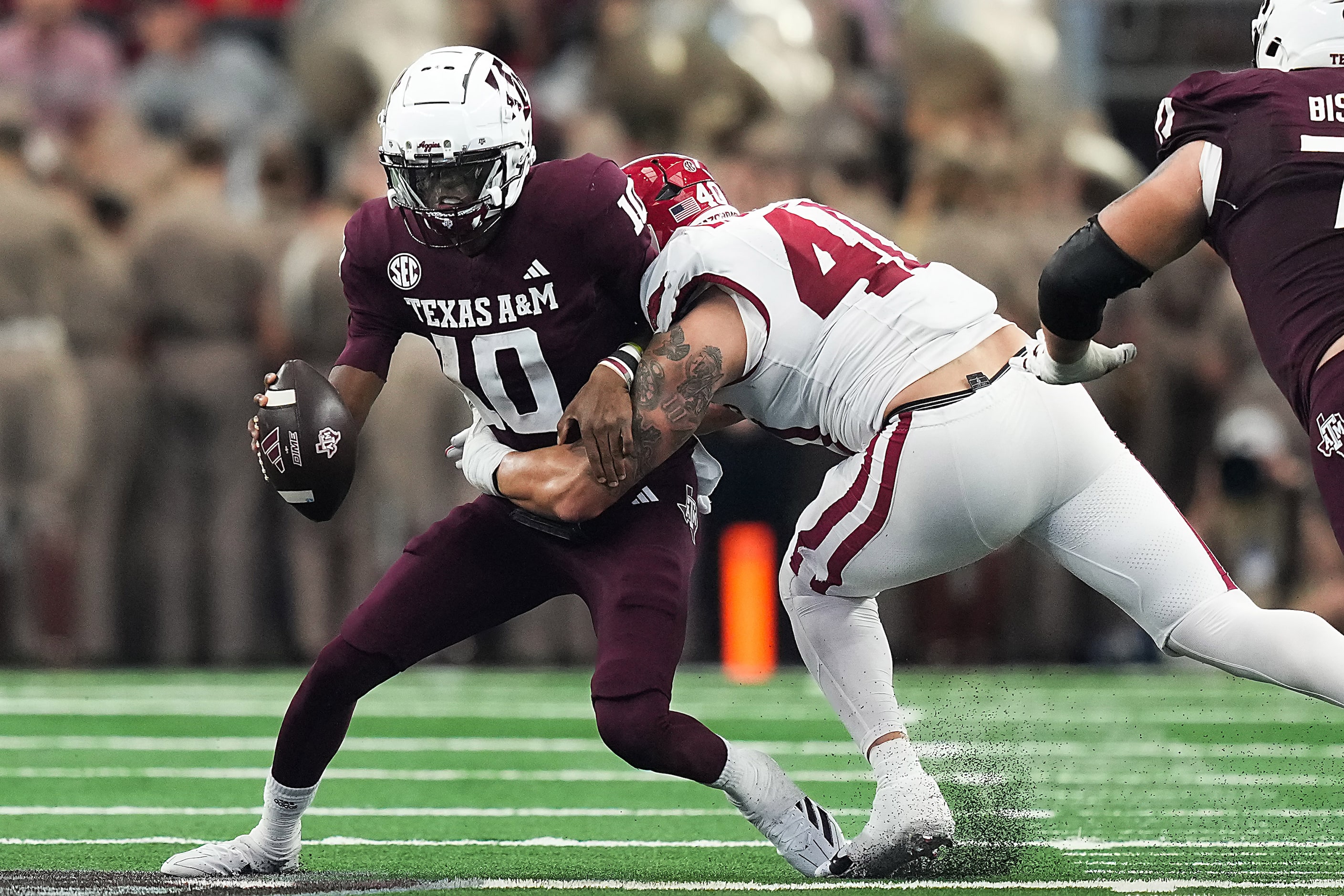 Texas A&M quarterback Marcel Reed (10) is sacked by Arkansas defensive lineman Landon...