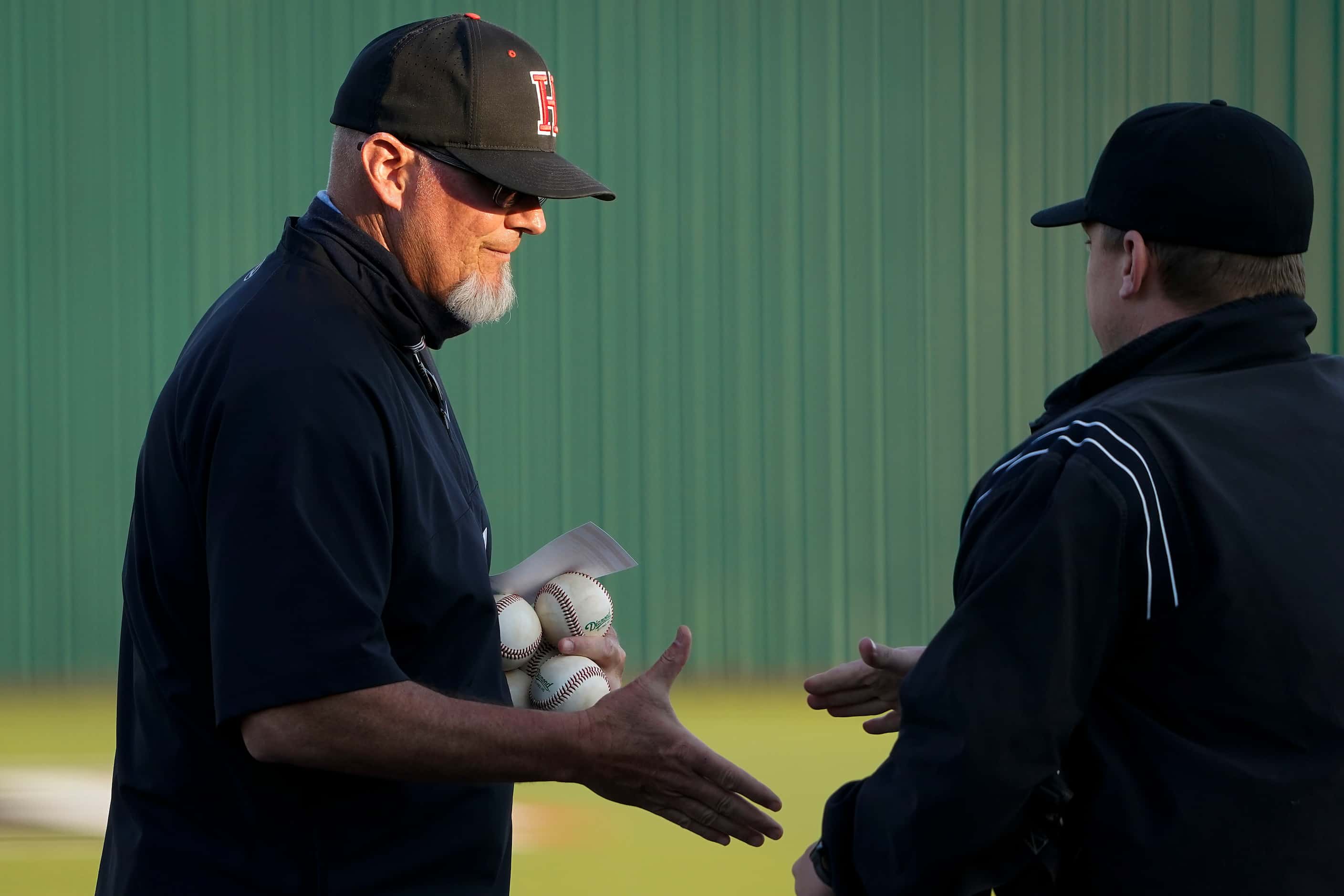 Rockwall-Heath head coach Greg Harvey takes out his lineup card before a district 10-6A high...