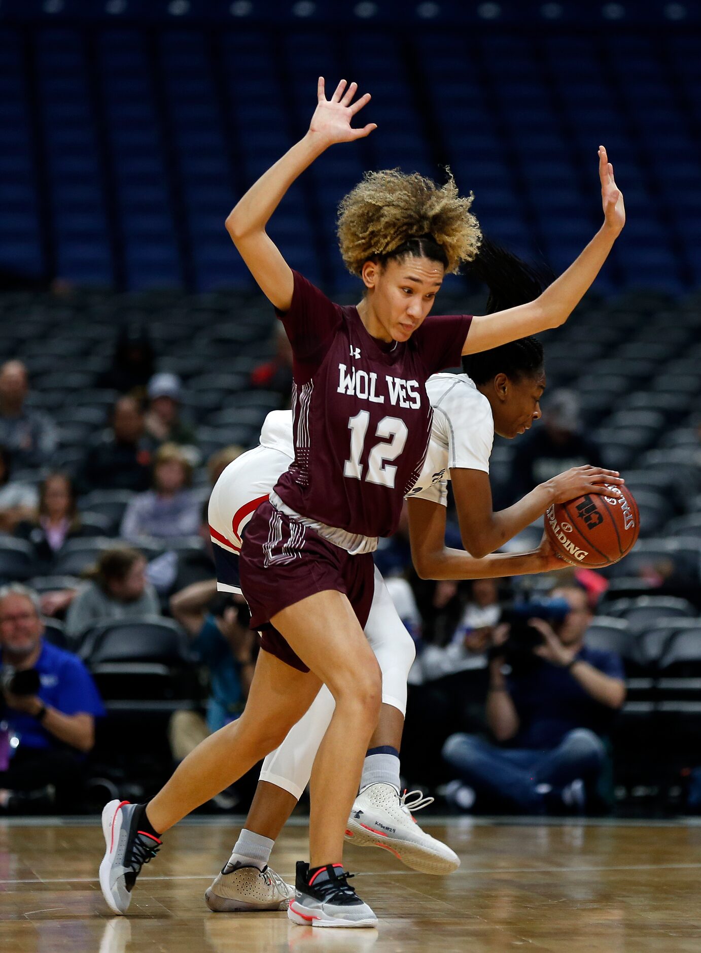 Mansfield Timberview guard Jasmynne Brown #12 avoids a foul after trying for a steal on...