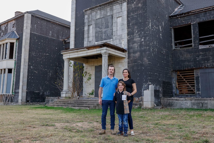 Isabel Ramey stands with her son Brady Hobbs, 7, and her partner, Kevin Martin, outside...