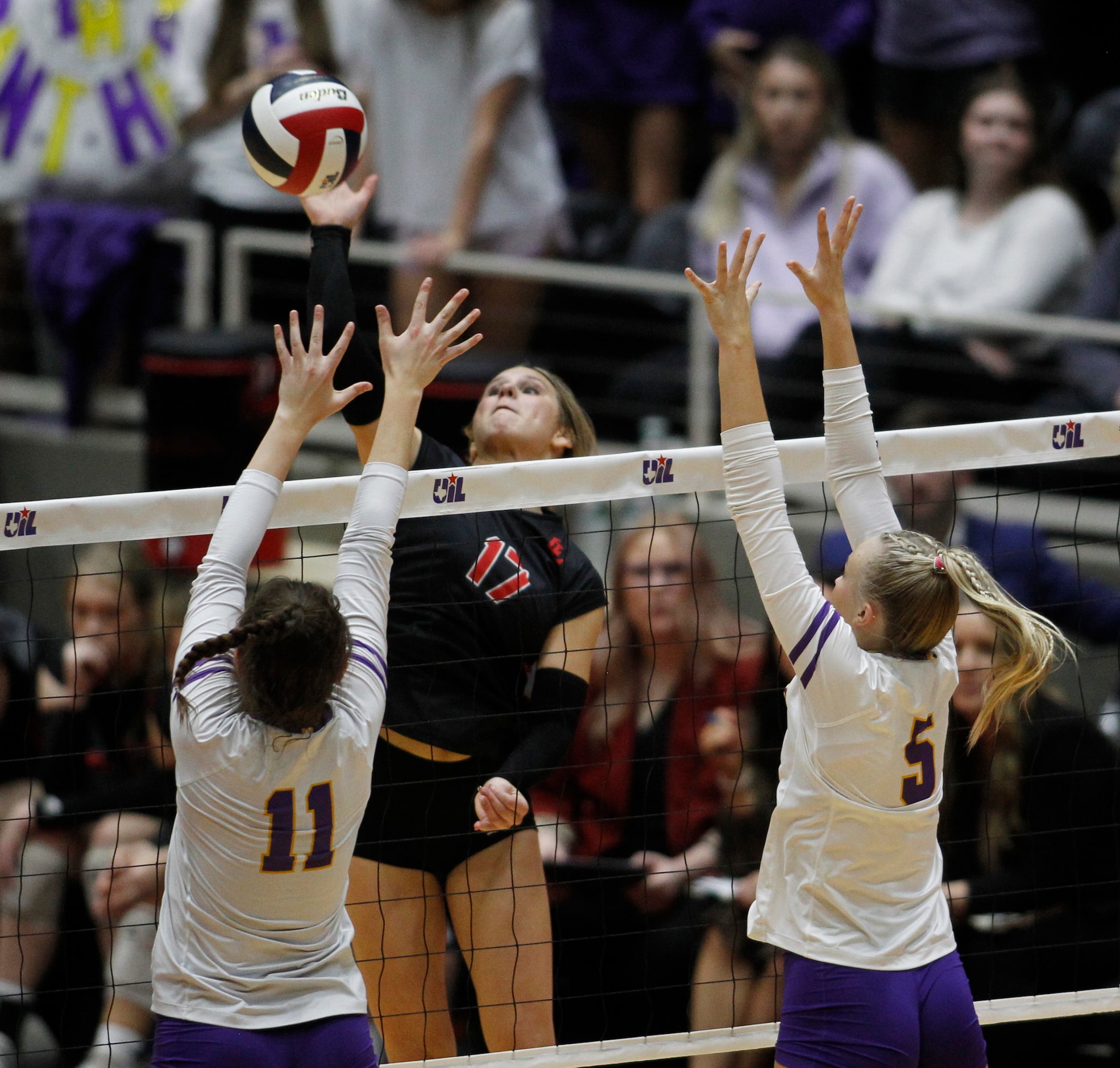 Lovejoy freshman Gentry Barker (17) spikes over the defense of Liberty Hill defenders Ava...